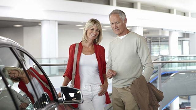 Buying a new car Griffin couple car showroom